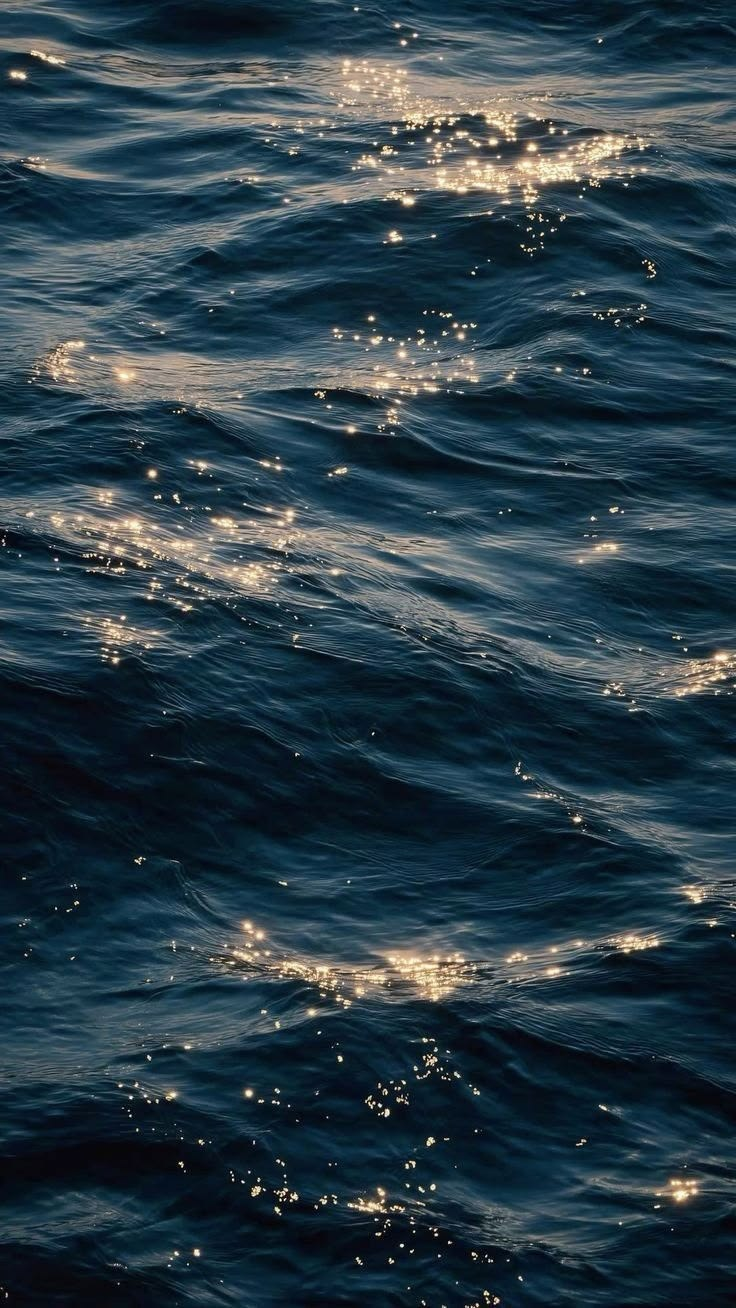 Sunlight sparkling on dark ocean waves
